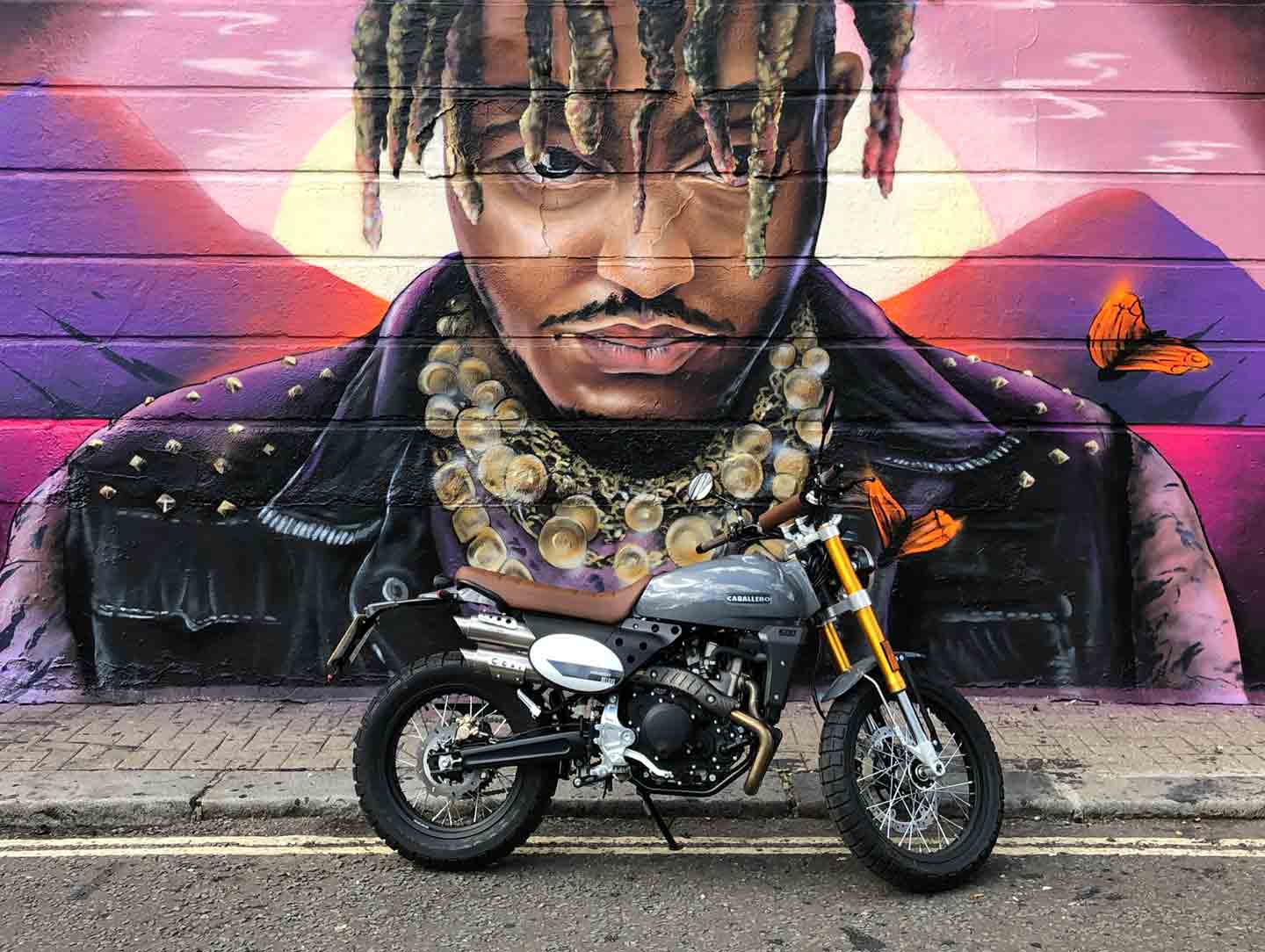 Caballero scrambler deluxe motorcycle in front of graffiti