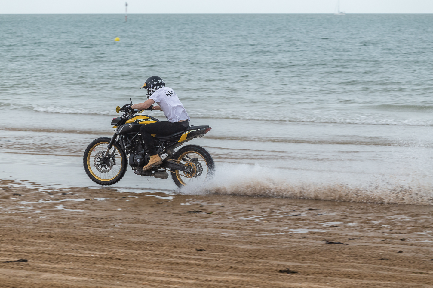 Motorcycle riding through the sea waves