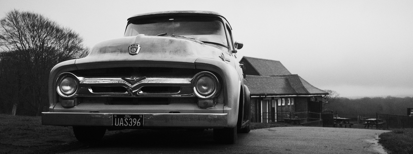 Black and white photo of hot rods at the Detonators monthly meet.